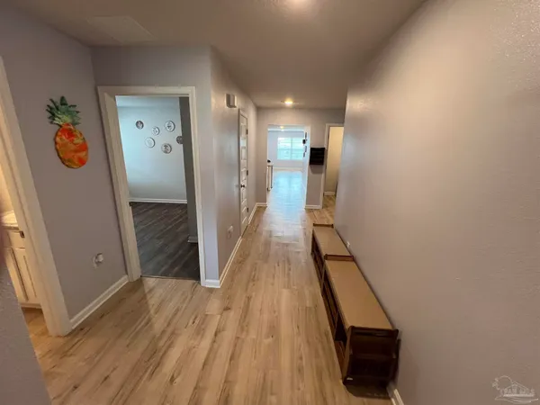a view of a hallway view with wooden floor and staircase