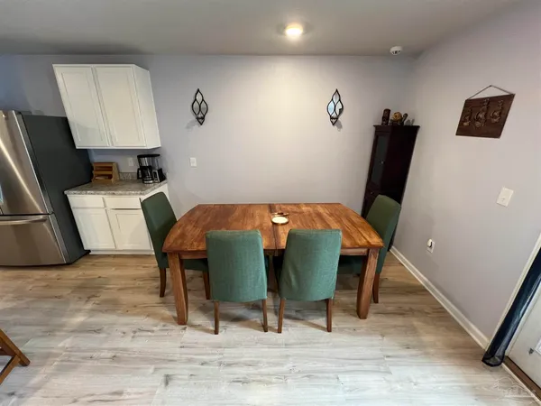a view of a workspace with furniture and wooden floor