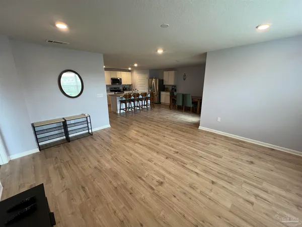 a view of a room with wooden floor and window