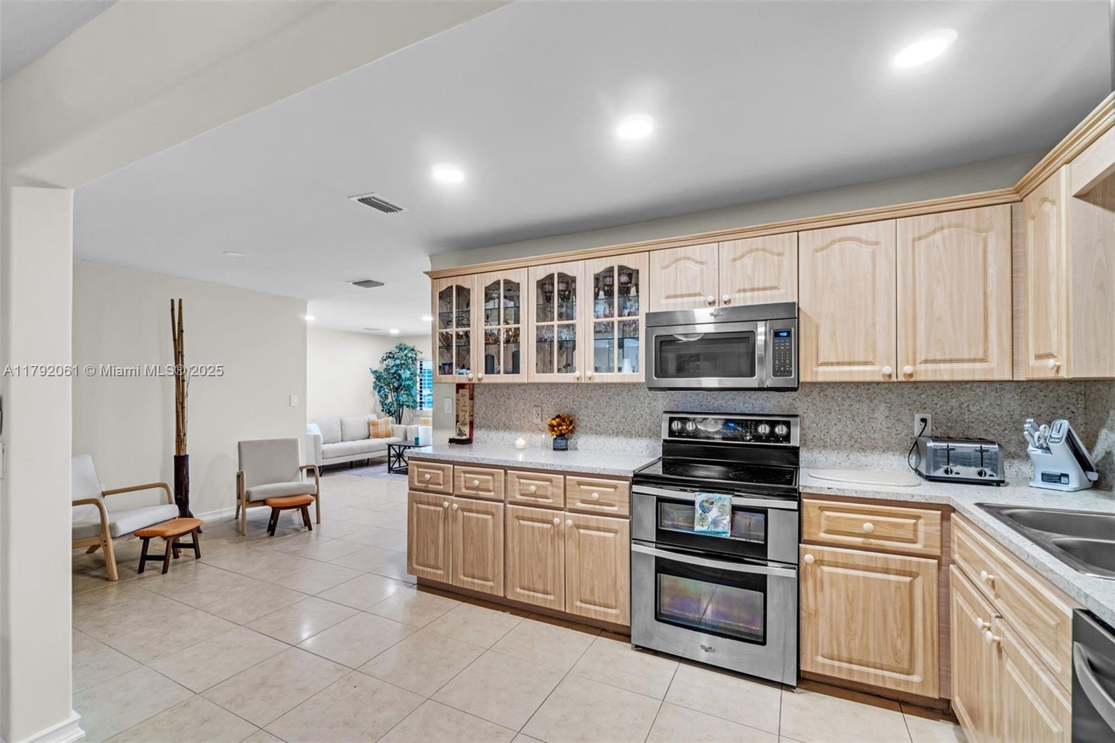 30021 Southwest 160th Avenue Homestead, FL 33033 - Photo 12 of 55 a kitchen with stainless steel appliances granite countertop a stove and cabinets