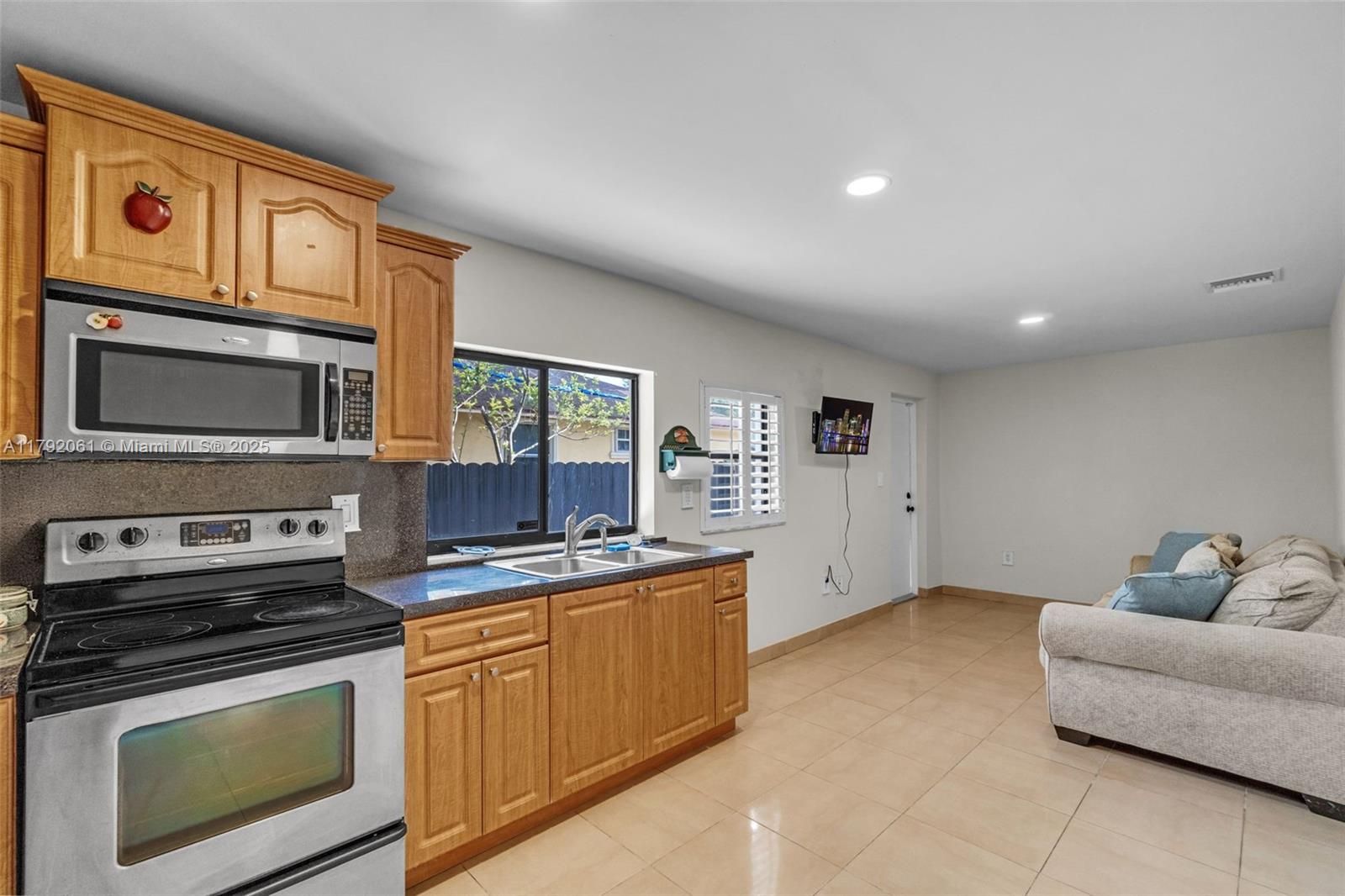 30021 Southwest 160th Avenue Homestead, FL 33033 - Photo 18 of 55 a kitchen with stainless steel appliances granite countertop a stove and a microwave