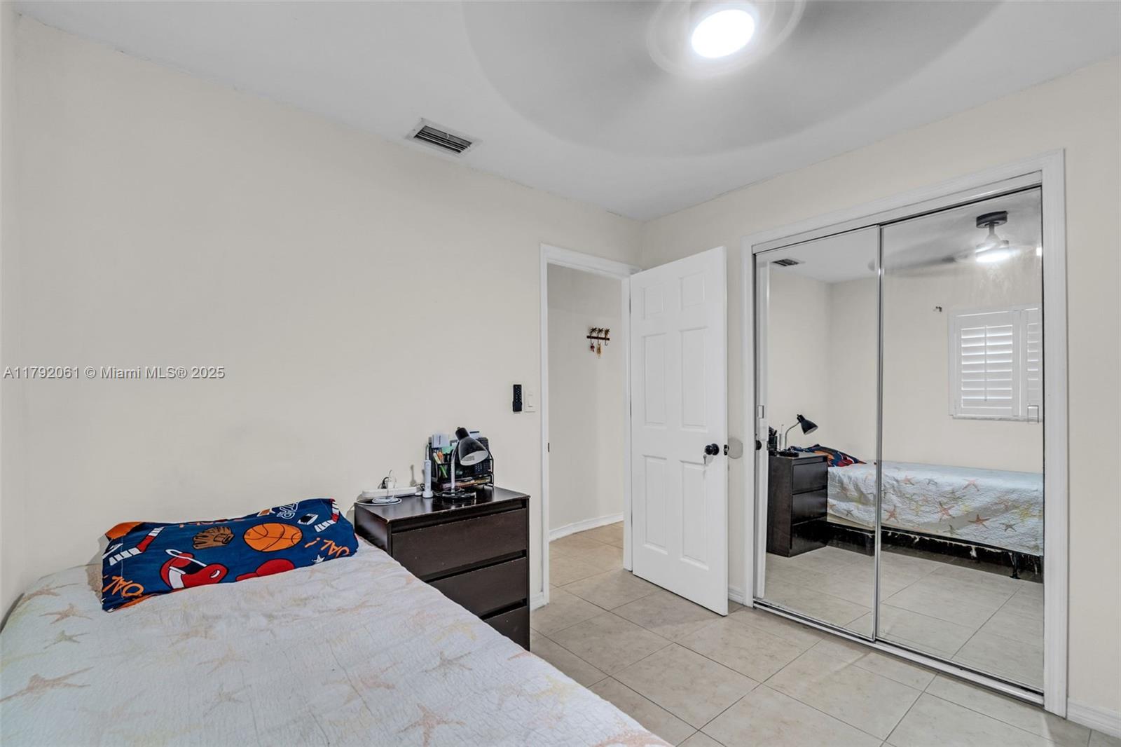 30021 Southwest 160th Avenue Homestead, FL 33033 - Photo 23 of 55 a bedroom with a bed and a walk in closet