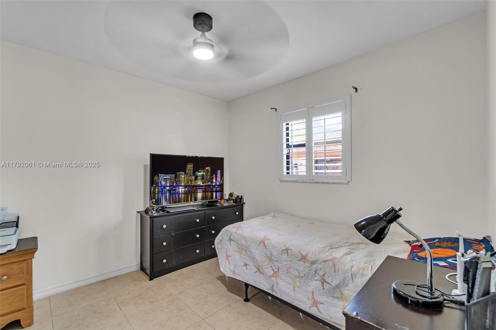 30021 Southwest 160th Avenue Homestead, FL 33033 - Photo 26 of 55 a bedroom with a bed and a flat tv screen on the dresser