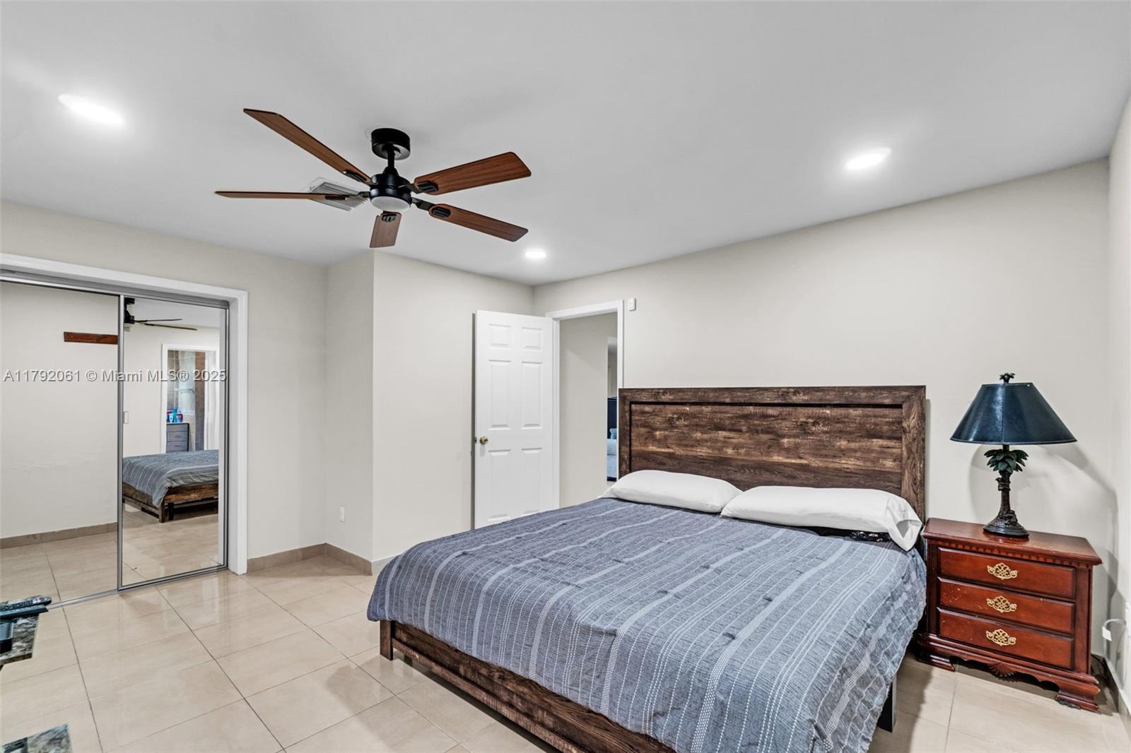 30021 Southwest 160th Avenue Homestead, FL 33033 - Photo 31 of 55 a bedroom with a bed and a chandelier