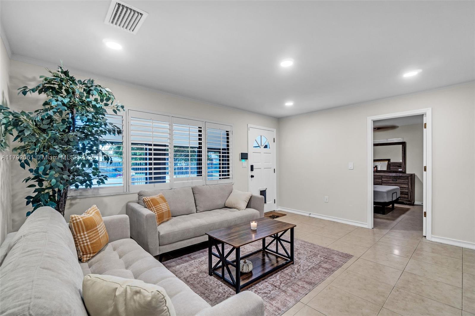 30021 Southwest 160th Avenue Homestead, FL 33033 - Photo 6 of 55 a living room with furniture and a large window