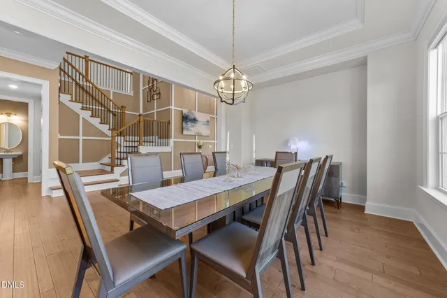 a kitchen with stainless steel appliances granite countertop a stove a sink and a refrigerator with wooden floor