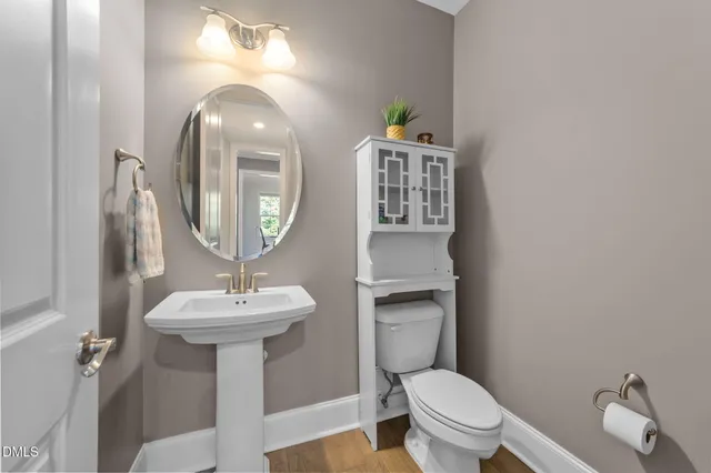a bathroom with a sink toilet vanity and shower