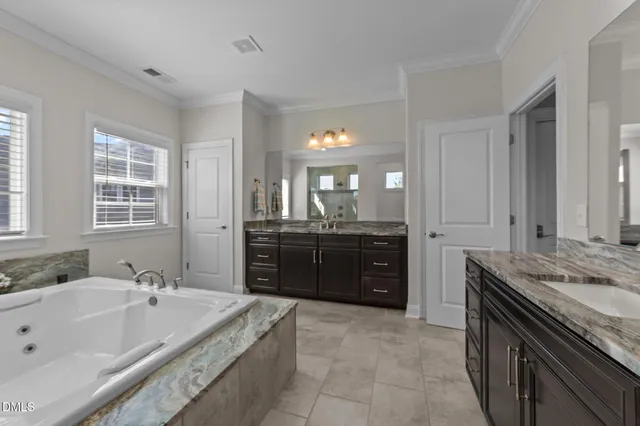 a living room with furniture a ceiling fan and a large window