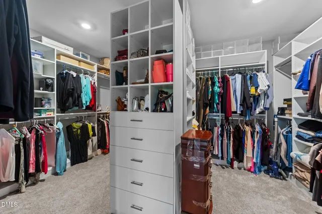 a spacious bedroom with a large bed and a large window