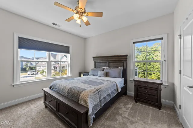 a view of a house with backyard water fountain and sitting area