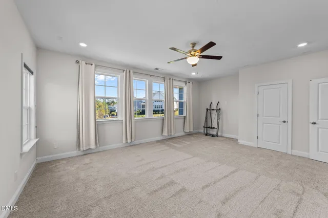 an aerial view of a house with a yard and large trees
