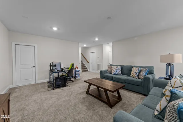 an aerial view of a house with swimming pool and outdoor seating