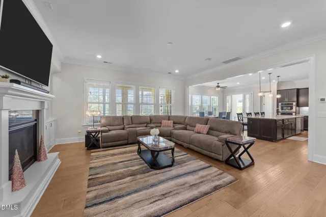 a living room with furniture and two window