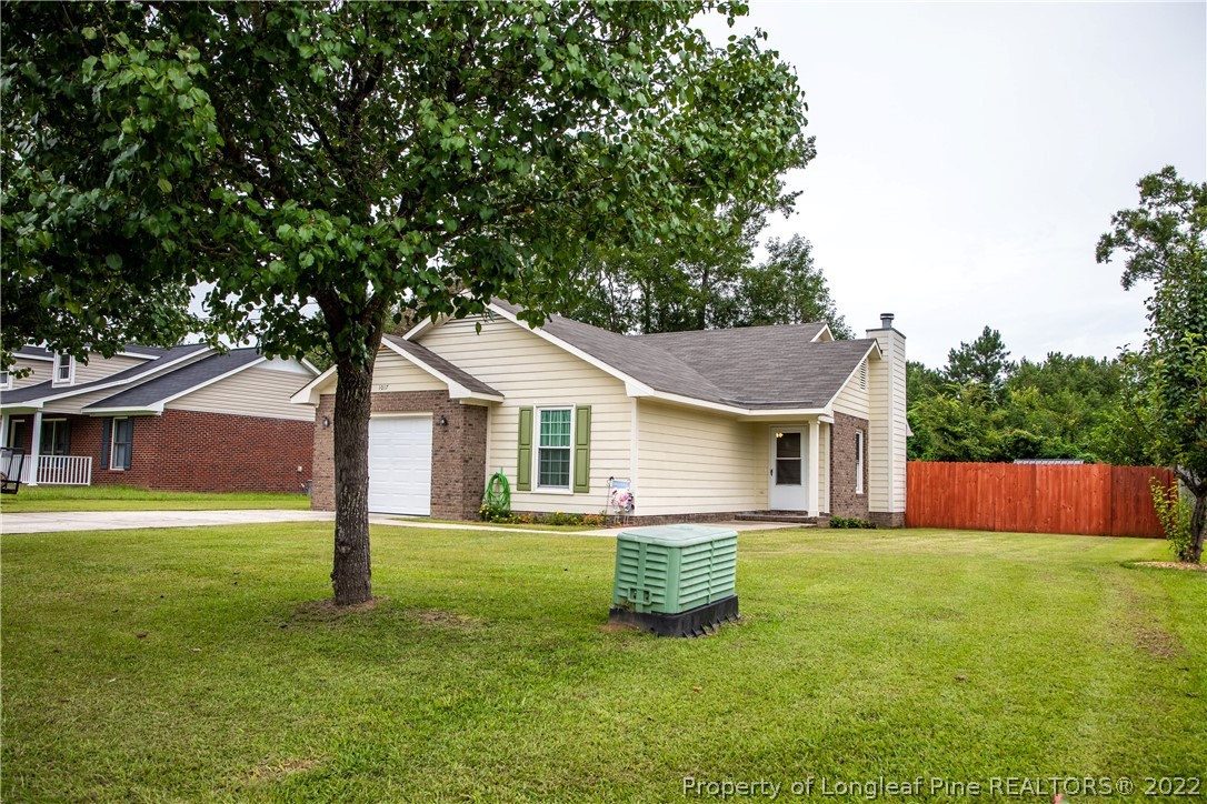 1017 Locks Creek Road Fayetteville, NC 28312 - Photo 2 of 26 a view of a house with a yard and a large tree