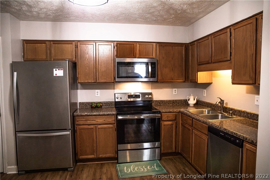 1017 Locks Creek Road Fayetteville, NC 28312 - Photo 5 of 26 a kitchen with a sink stove and microwave