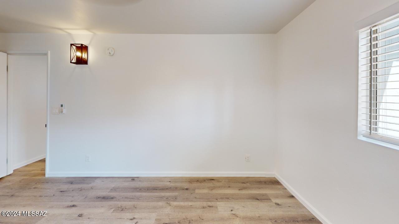 2118 North Rita Avenue Tucson, AZ 85716 - Photo 6 of 17 an empty room with wooden floor and windows