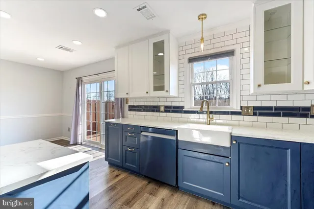 a spacious bathroom with a granite countertop sink mirror and a