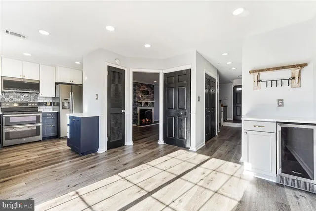 a kitchen with stainless steel appliances kitchen island granite countertop a refrigerator and a stove top oven