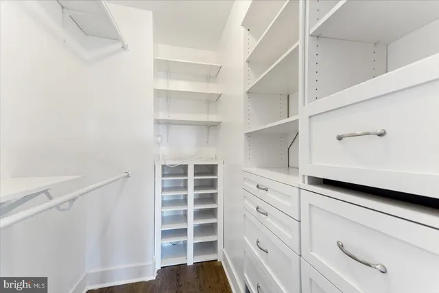 a view of walk in closet with empty racks
