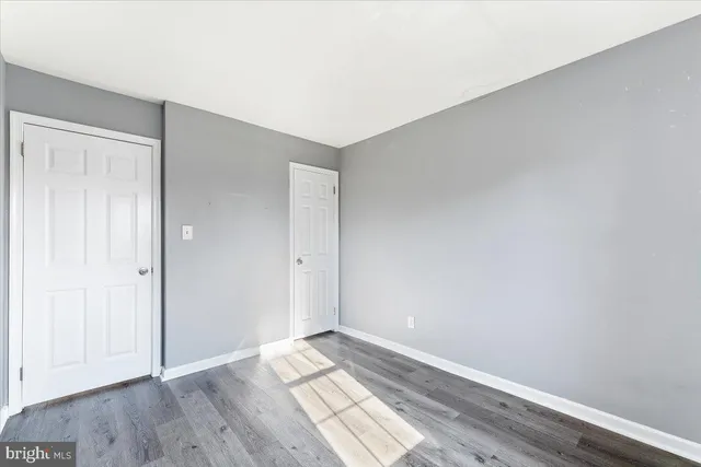 an empty room with wooden floor