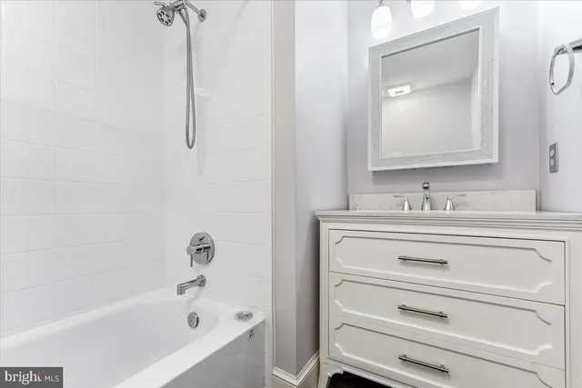 a bathroom with a sink a bathtub and a mirror