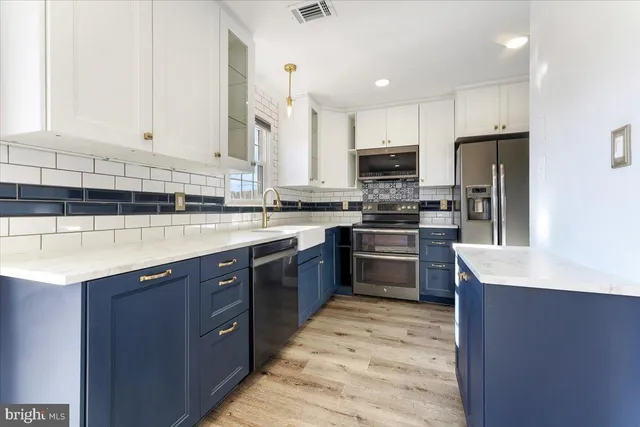 a kitchen with stainless steel appliances granite countertop a stove a sink dishwasher a refrigerator and a oven