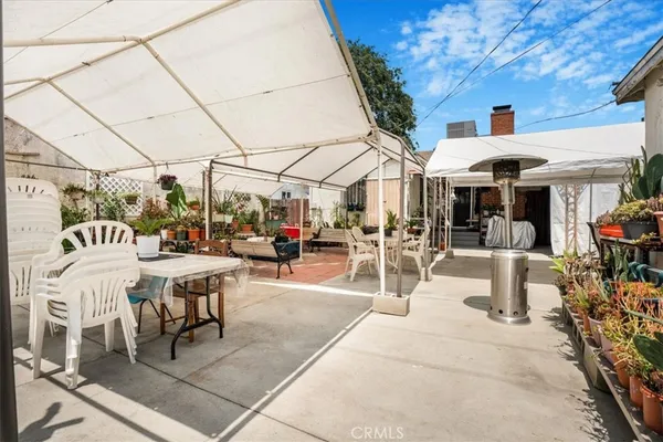a view of a patio with a table and chairs under an umbrella