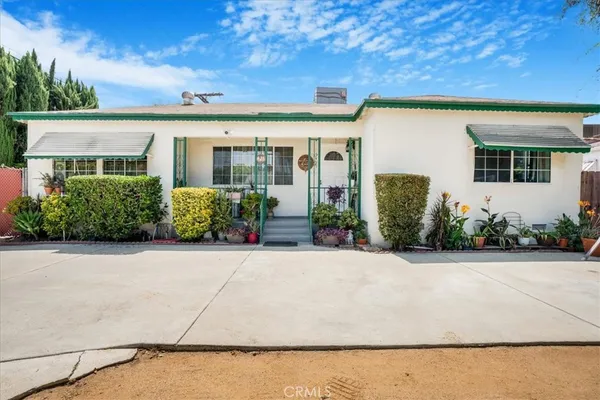 front view of a house with potted plants
