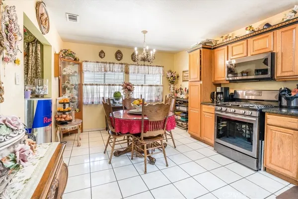 a kitchen with stainless steel appliances kitchen island granite countertop a stove a sink and a microwave