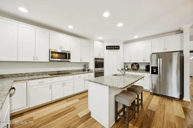 a kitchen with granite countertop a sink and cabinets