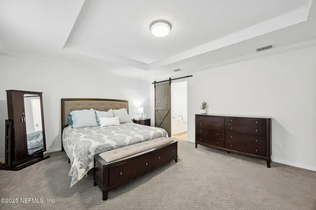 a bedroom with a bed and a couch