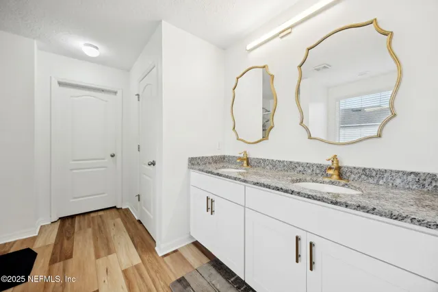 a view of a room with wooden floor pool table and windows