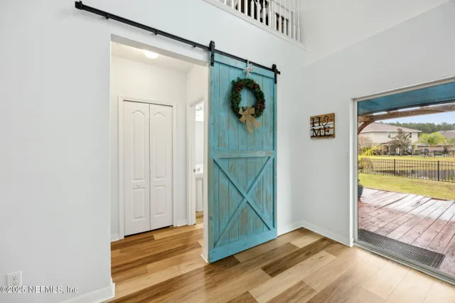 a view of a swimming pool with a lounge chair and palm trees
