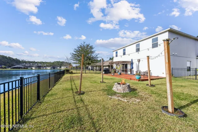a view of a swimming pool is in front of a house