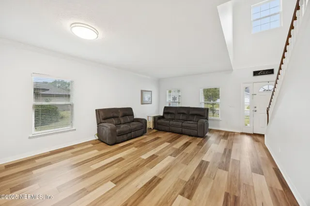 a view of a workspace with furniture and wooden floor