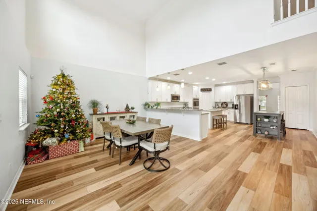 a dining room with furniture and wooden floor