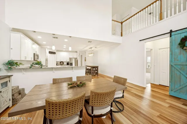 a view of a dining room with furniture and wooden floor