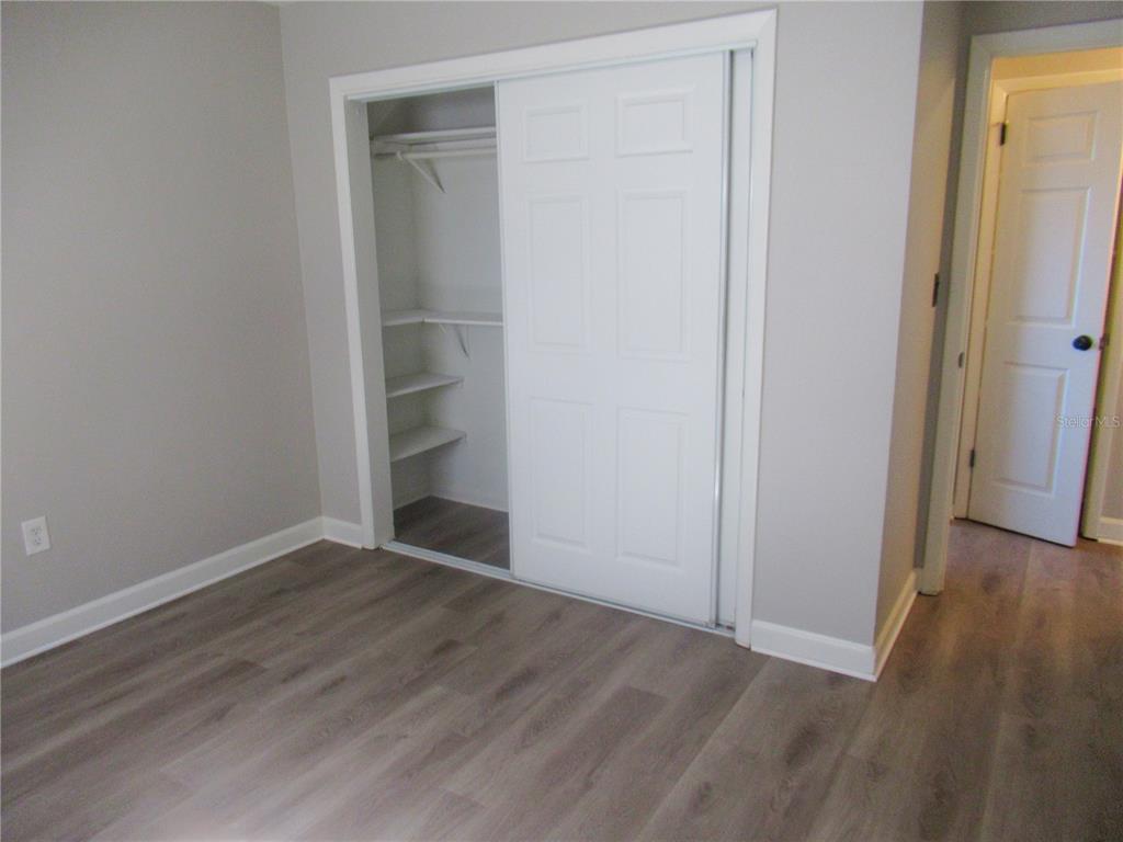1798 Faulds Road North Clearwater, FL 33756 - Photo 15 of 34 an empty room with wooden floor and closet
