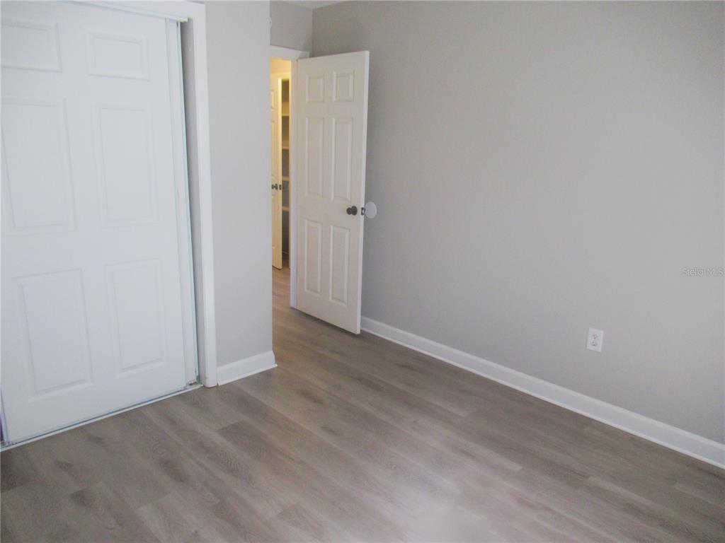 1798 Faulds Road North Clearwater, FL 33756 - Photo 16 of 34 an empty room with wooden floor