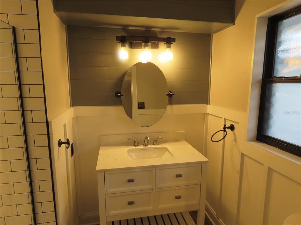 1798 Faulds Road North Clearwater, FL 33756 - Photo 21 of 34 a bathroom with a sink and mirror