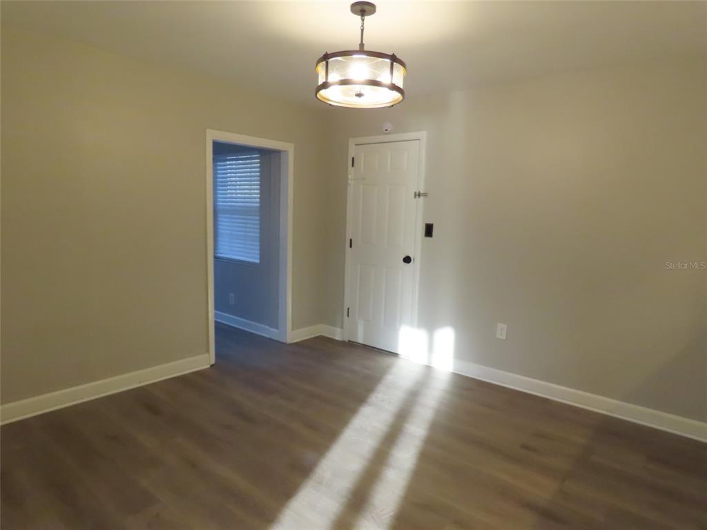 1798 Faulds Road North Clearwater, FL 33756 - Photo 7 of 34 wooden floor in an empty room with a window