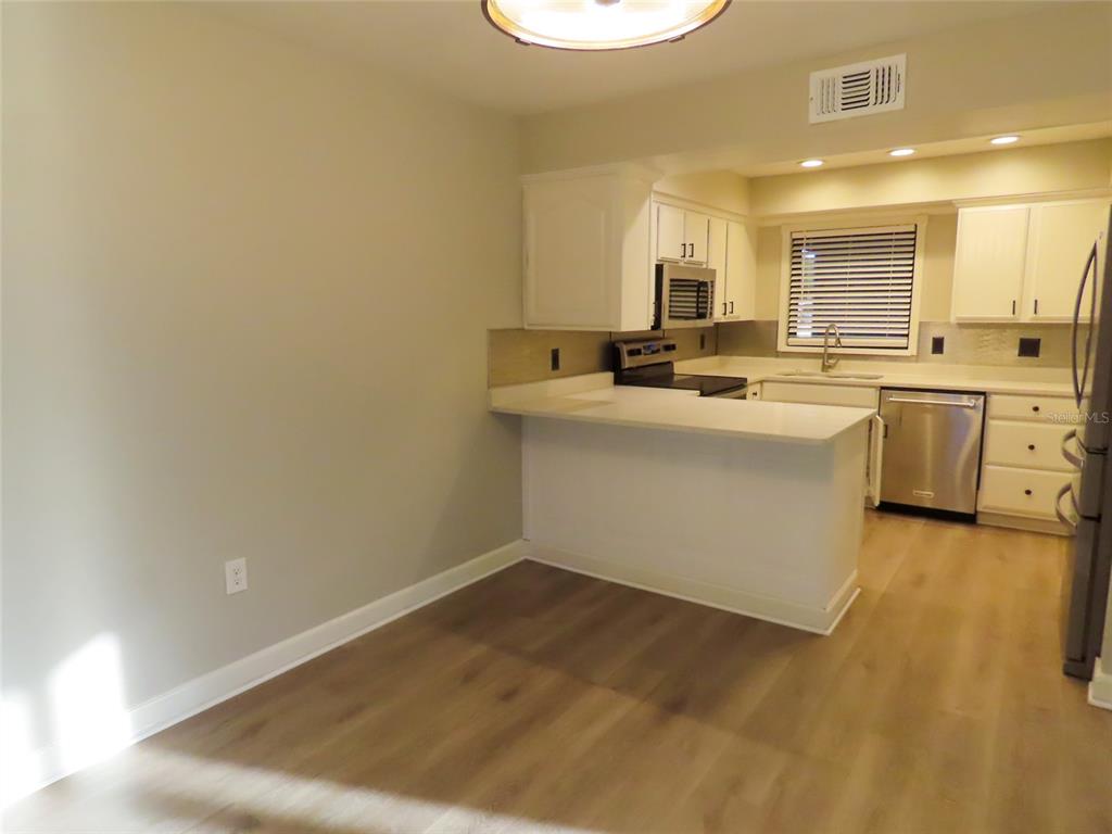 1798 Faulds Road North Clearwater, FL 33756 - Photo 9 of 34 a kitchen with sink and cabinets