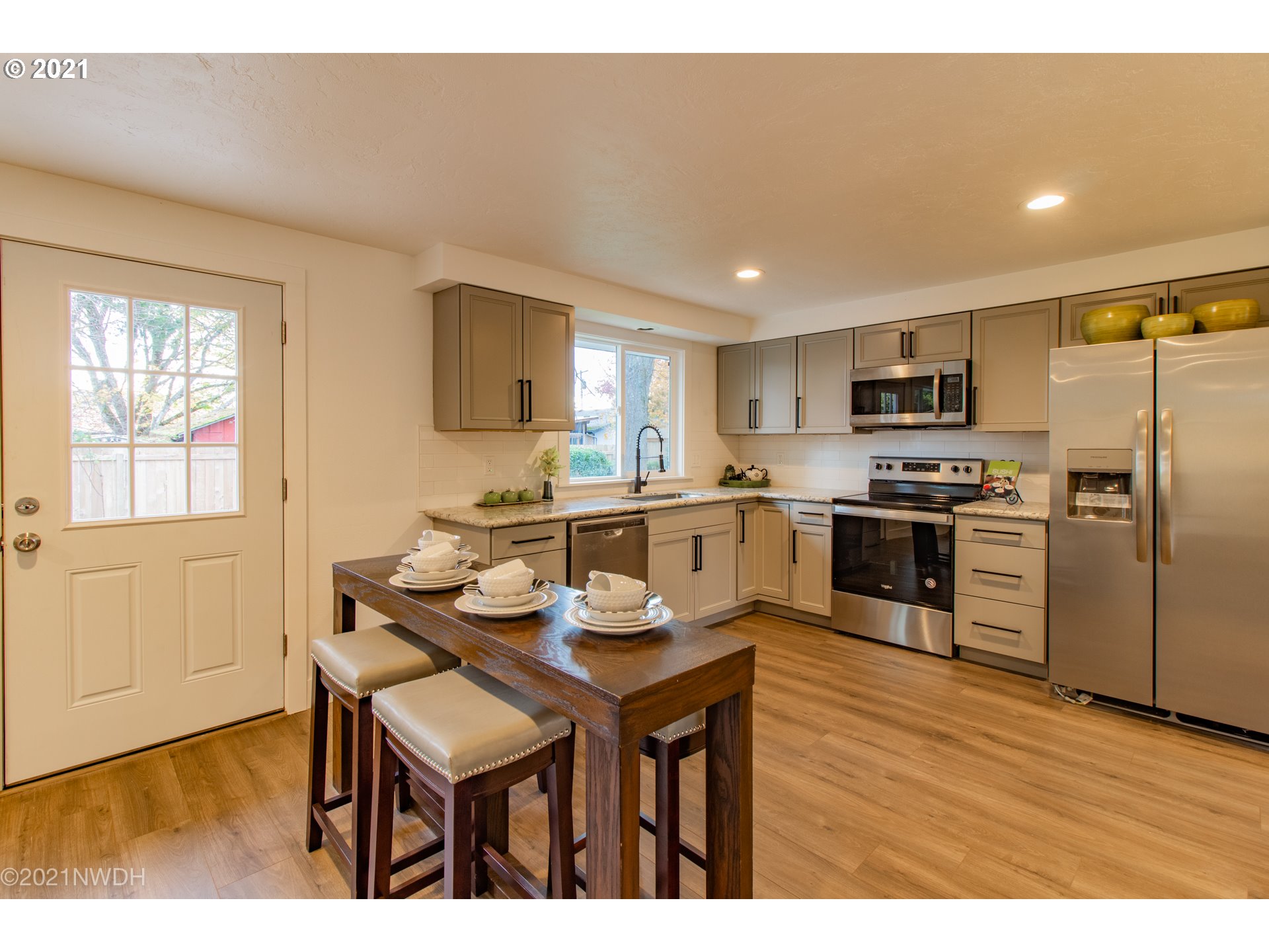 1481 T Street Springfield, OR 97477 - Photo 8 of 21 a kitchen with refrigerator cabinets and wooden floor