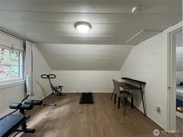 a room with wooden floor and furniture