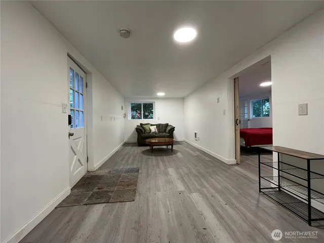 a bedroom with a bed and a large window