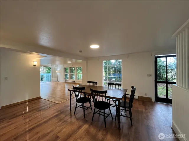 a view of a dining room with furniture and wooden floor