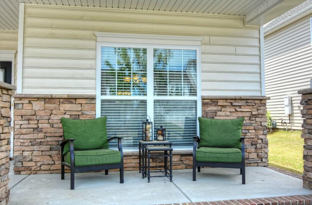 1628 Ridgehaven Road Waxhaw, NC 28173 - Photo 2 of 24 a view of a chair and tables in the back yard of the house