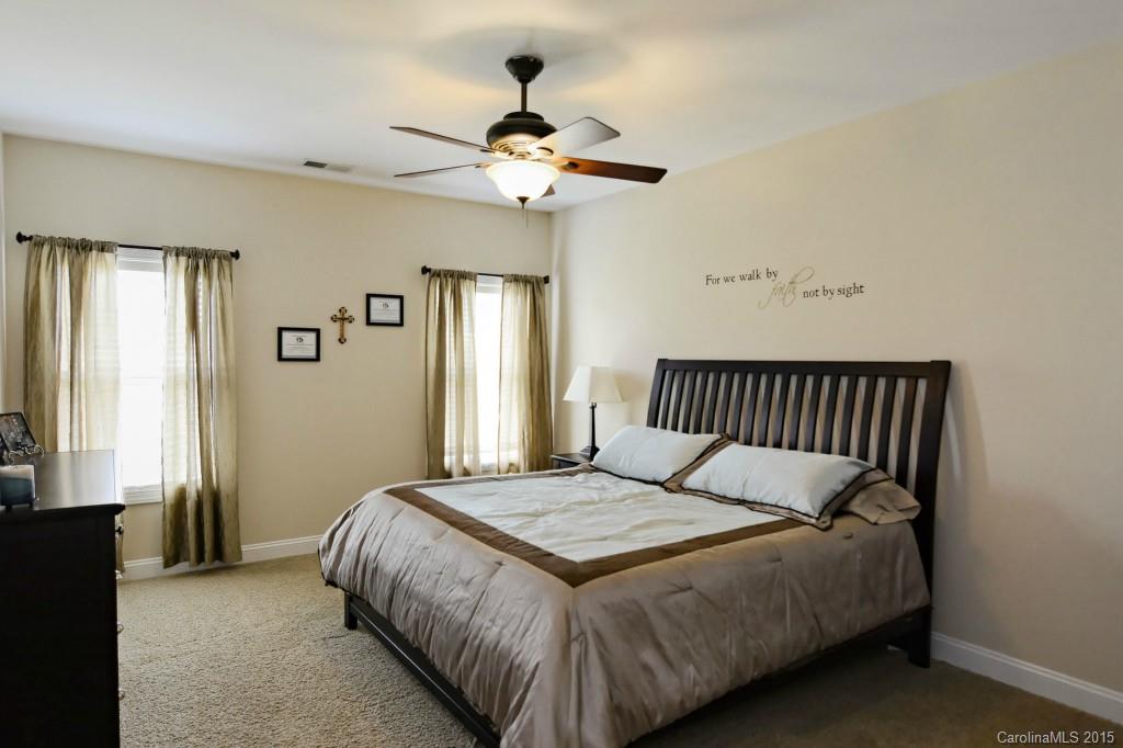 1628 Ridgehaven Road Waxhaw, NC 28173 - Photo 11 of 24 a bedroom with a large bed and a chandelier