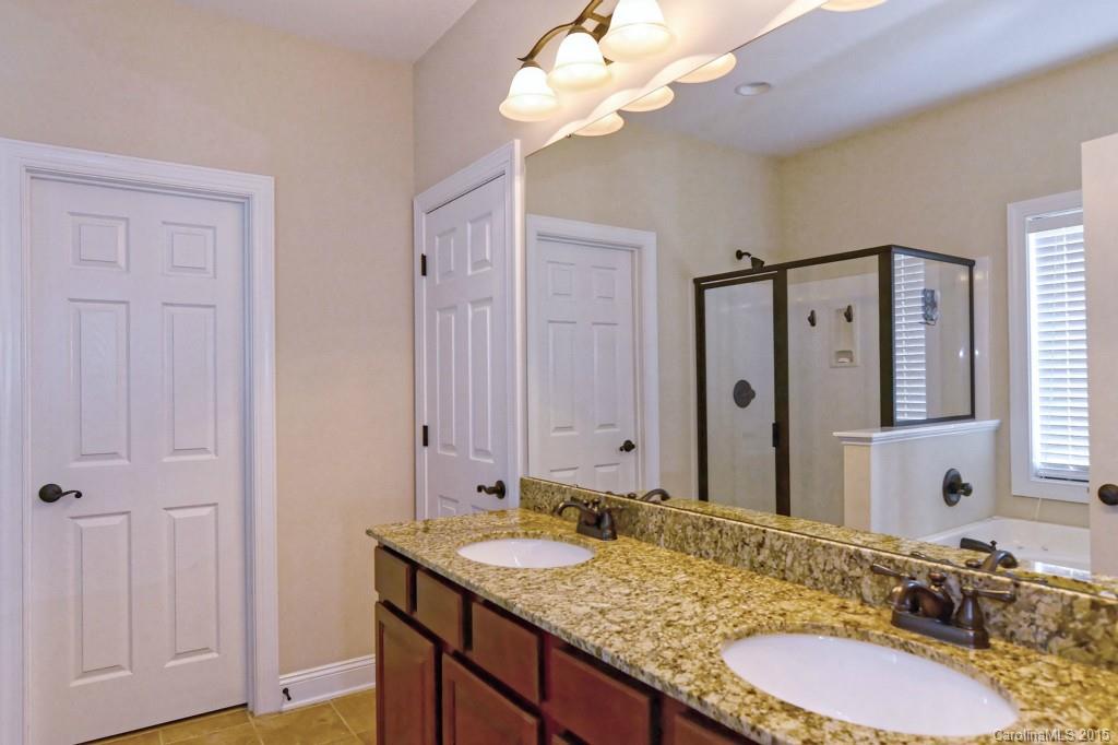 1628 Ridgehaven Road Waxhaw, NC 28173 - Photo 12 of 24 a bathroom with a granite countertop double vanity sink and a mirror