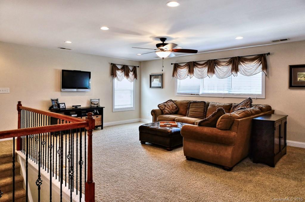 1628 Ridgehaven Road Waxhaw, NC 28173 - Photo 14 of 24 a living room with furniture and a flat screen tv